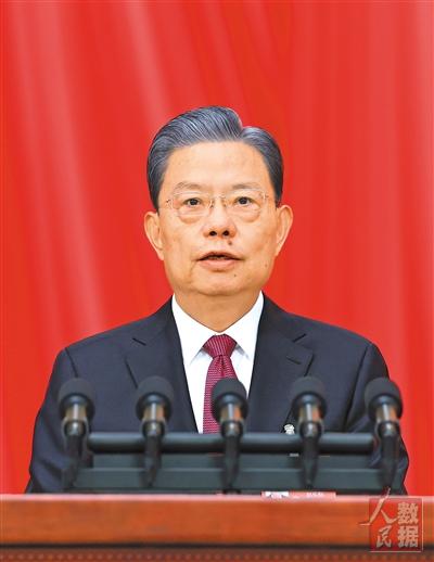 受全国人大常委会委托,赵乐际委员长向大会报告全国人大常委会工作.
